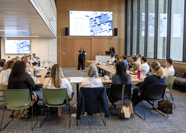 A instructor presenting to a room full of people.