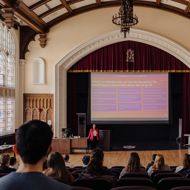 An instructor presenting to a classroom full of students.