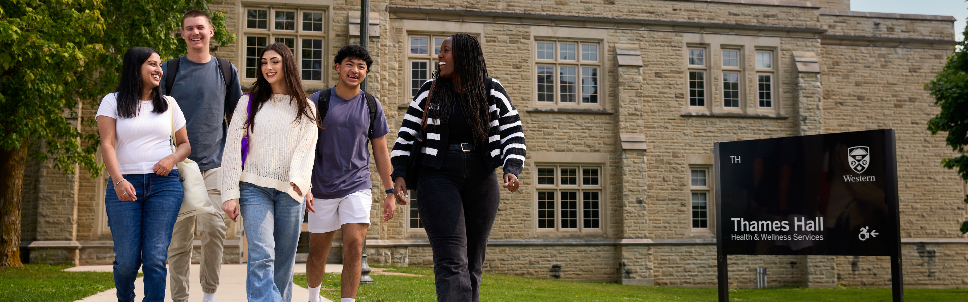 A group of students walking outside Thames Hall.