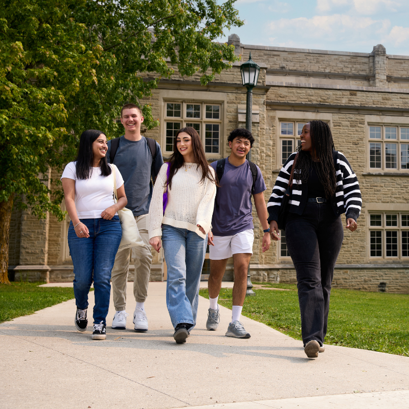 A group of students walking outside Thames Hall.
