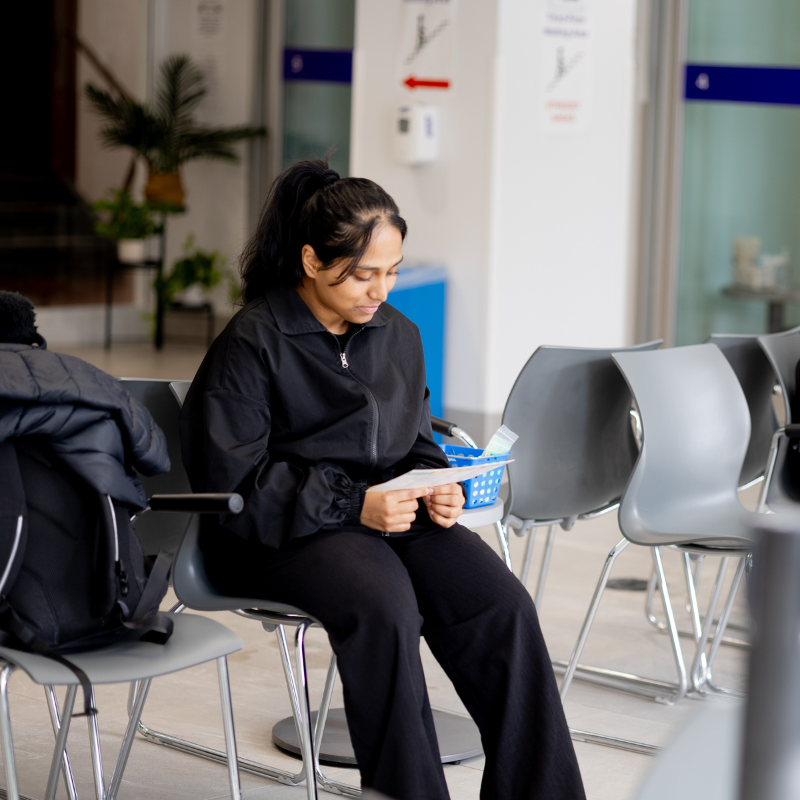 A young woman sitting in a clinic.