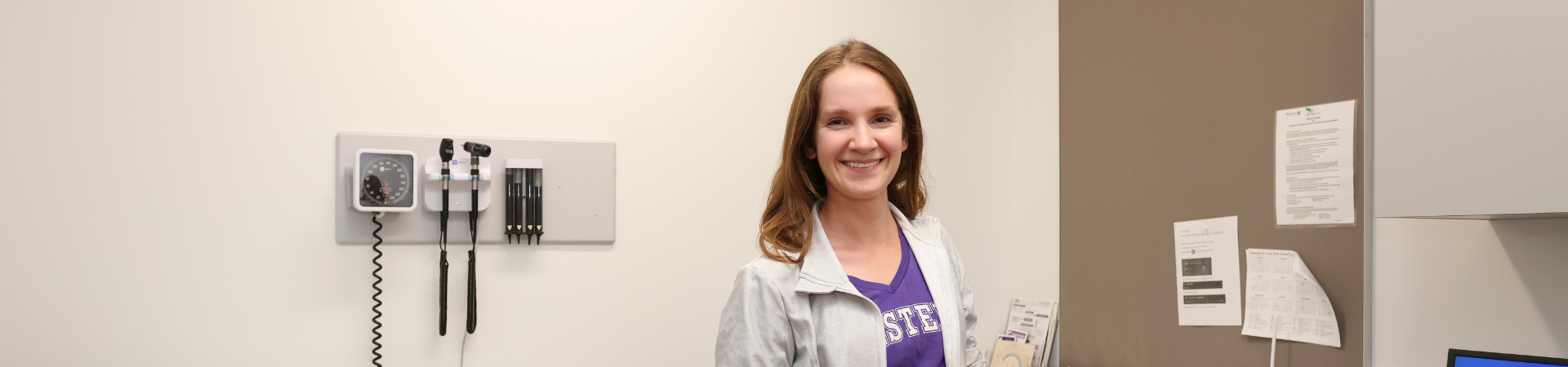 A nurse smiling in a doctor's office.