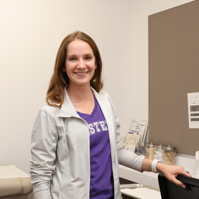 A nurse smiling in a doctor's office.