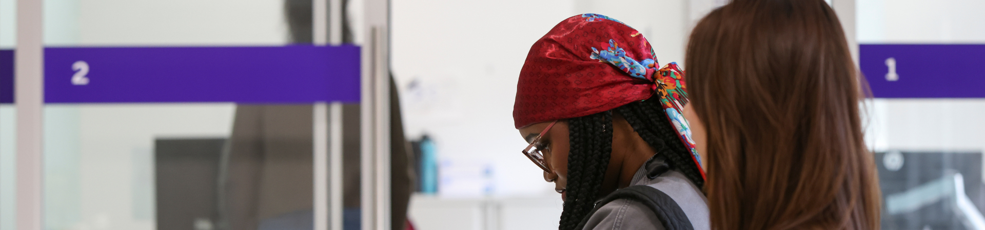 Two young women wait in a health clinic.