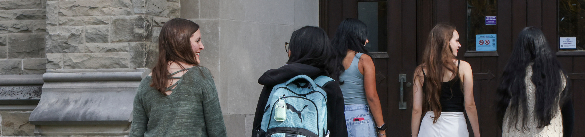 A young woman walks into Thames hall.