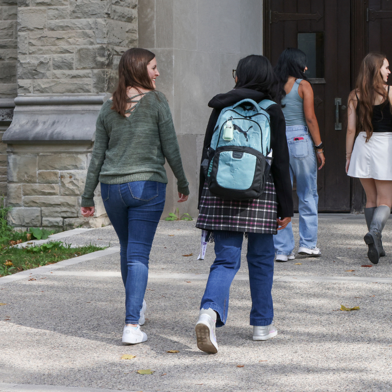 A young woman walks into Thames hall.