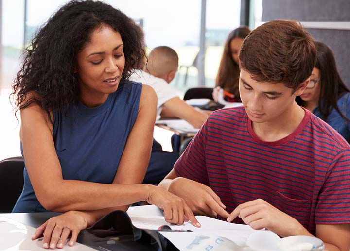 Women teaching a young boy