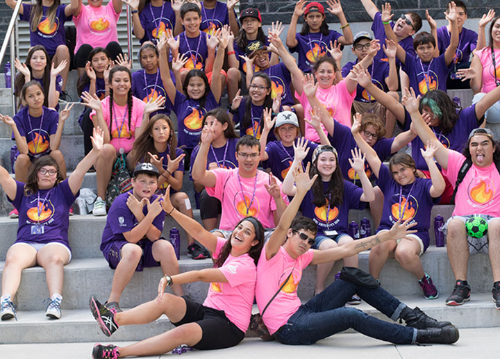 group of campers and staff posing for a picture on top of stairs