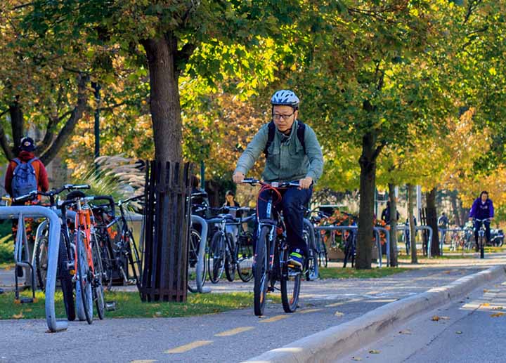 A person riding a bicycle through Western campus
