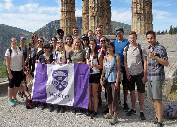Western students holding up a flag in Greece