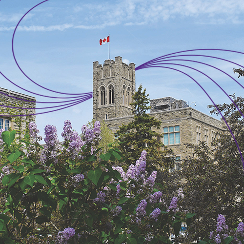University College Tower on a sunny day with Canada flag blowing in the wind.
