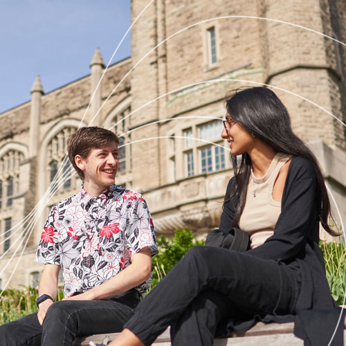 Two students sitting smiling at one another on campus. White wavy lines in the background.