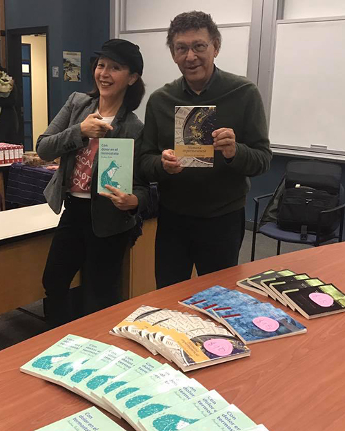 Authors Andrea Avila and Teobaldo Noriega pose happily with their books at the book launch hosted by Languages and Cultures