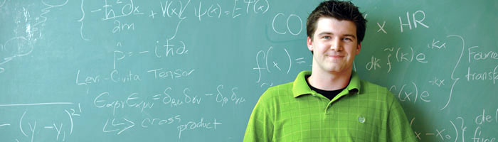 graduate student in front of a blackboard