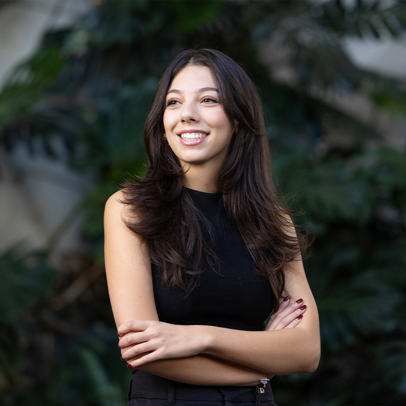 MES student smiling with arms crossed
