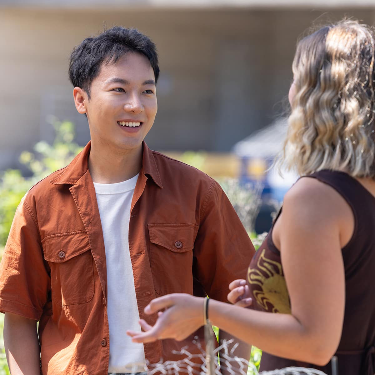 Two people talking outdoors
