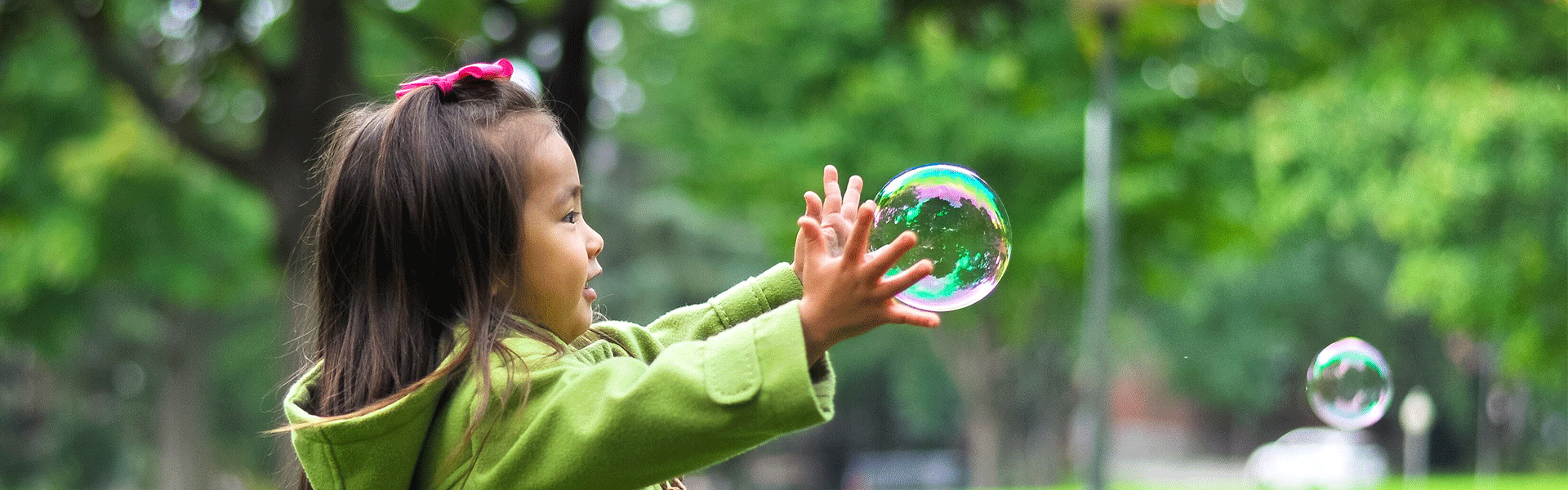 child chasing bubbles