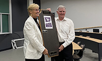 Al Morrow and Anglea Schneider hold a plaque