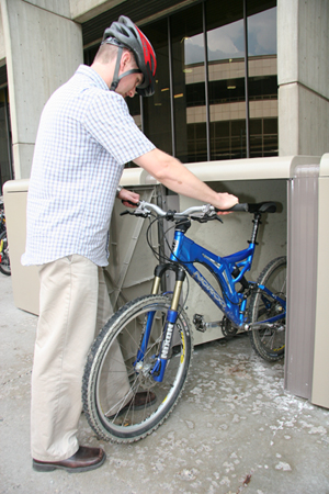 Man Putting Bike in Locker