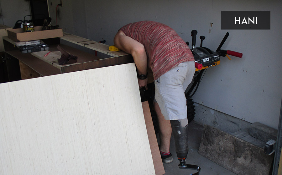 man with prosthetic leg doing carpentry work