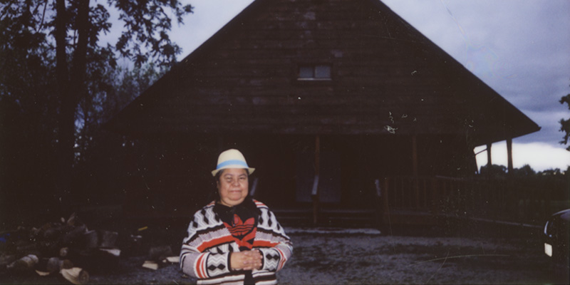 patient standing outside of cottage