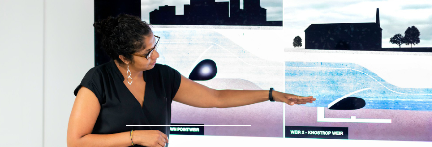An engineer presents on a smart board