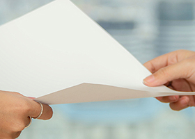 decorative image of two hands passing a piece of paper