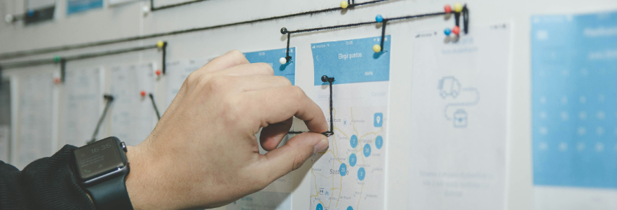 Hand pinning lists and papers to a pin board