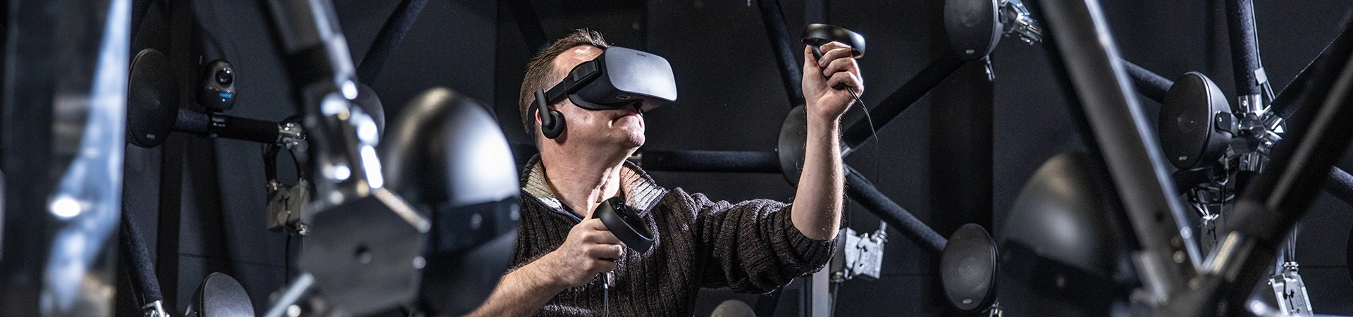 A male research subject uses virtual reality within the audiodome at the Brain & Mind Core Research Facility