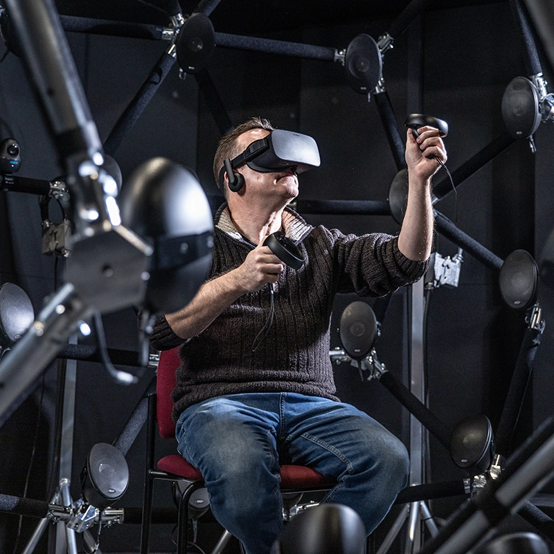 A male research subject uses virtual reality within the audiodome at the Brain & Mind Core Research Facility