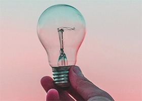 Lightbulb against a sunset sky