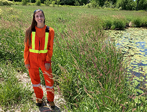 Katrina Wynne standing in safety gear in a field