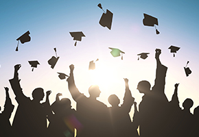 Graduating students tossing hats in air