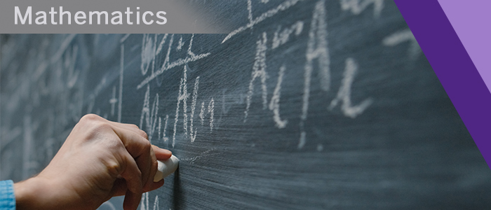 Hand writing math equations on chalk board