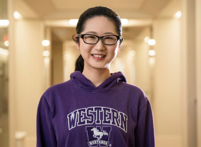 Student in Western sweatshirt smiles for the camera