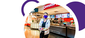 Hospitality Services staff member in front of Quesada outlet