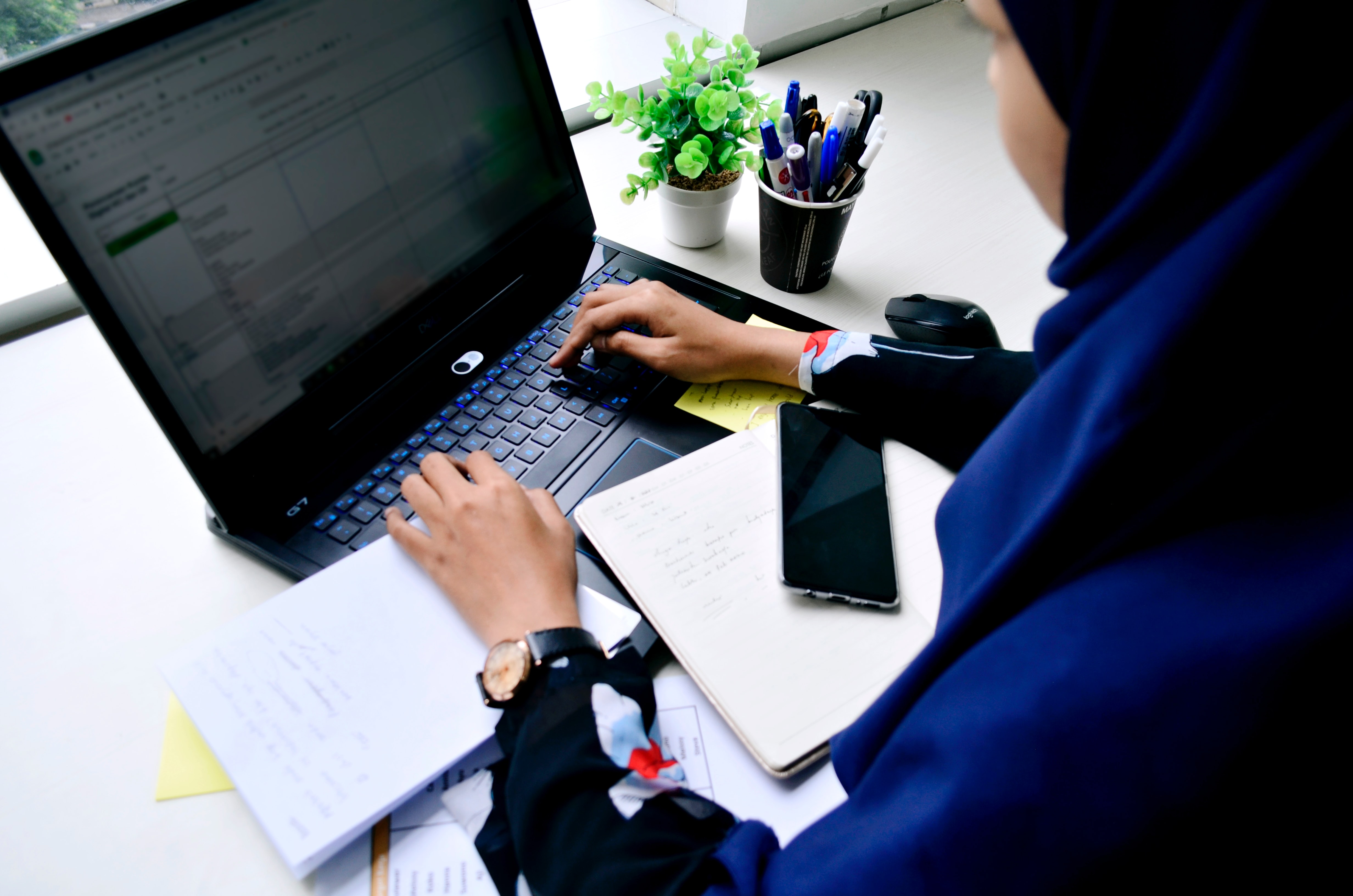 Woman typing at computer