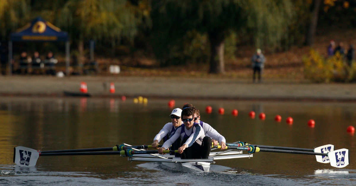 A photo of the Mustang Men's Rowing team in the water on a sunny fall day