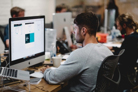 Man working at a desktop computer.