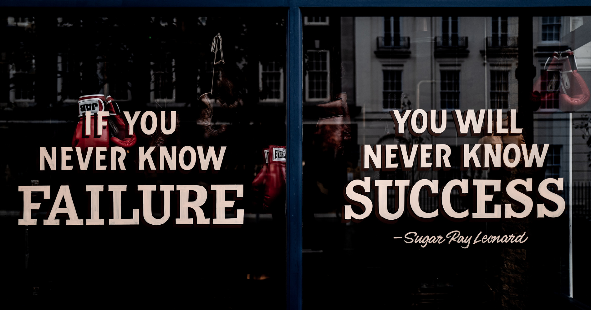 A sign in a window that reads "if you never know failure, you will never know success"