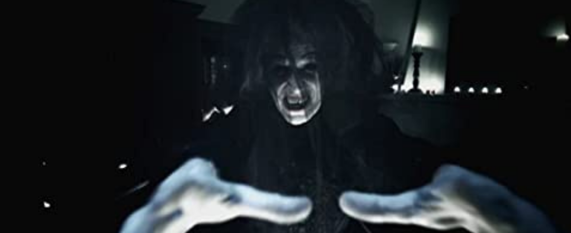 A still image of a creepy woman from the movie Insidious