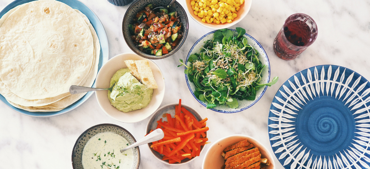 Ingredients for quesadillas laid out in bowls on a counter top 