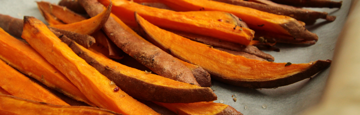 sliced sweet potatoes sitting in a baking tray
