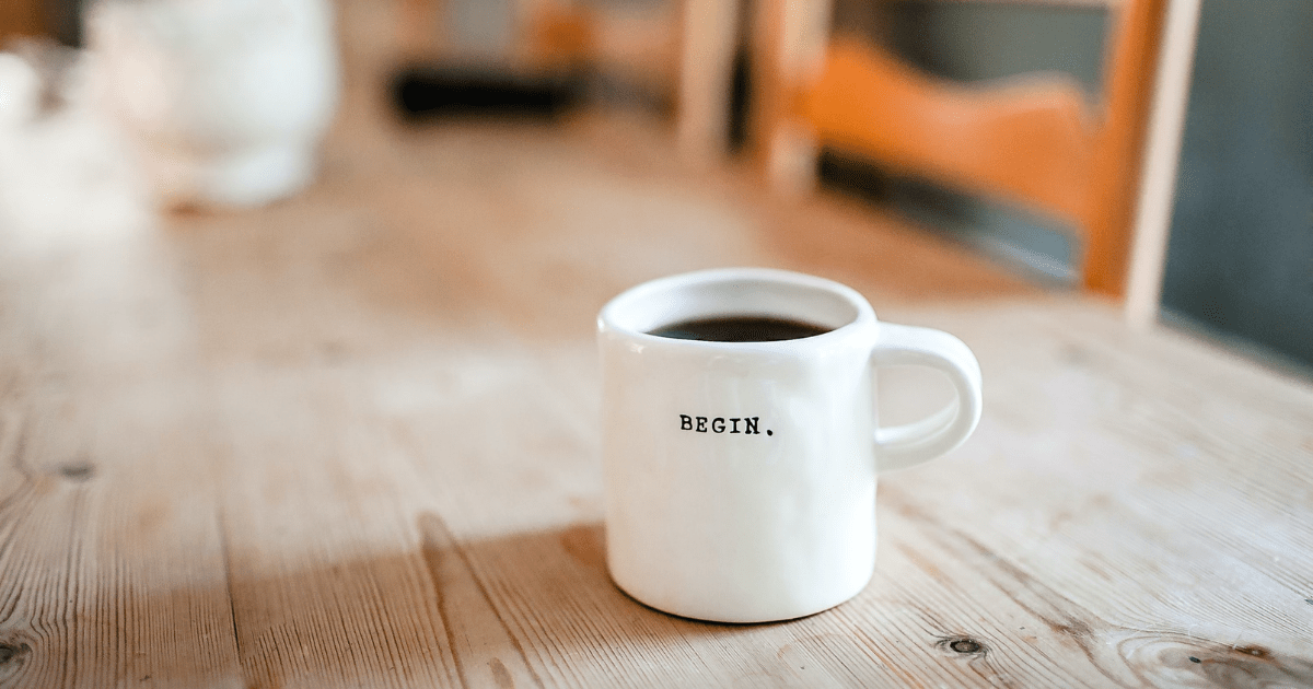 A white coffee mug sitting on a coffee table