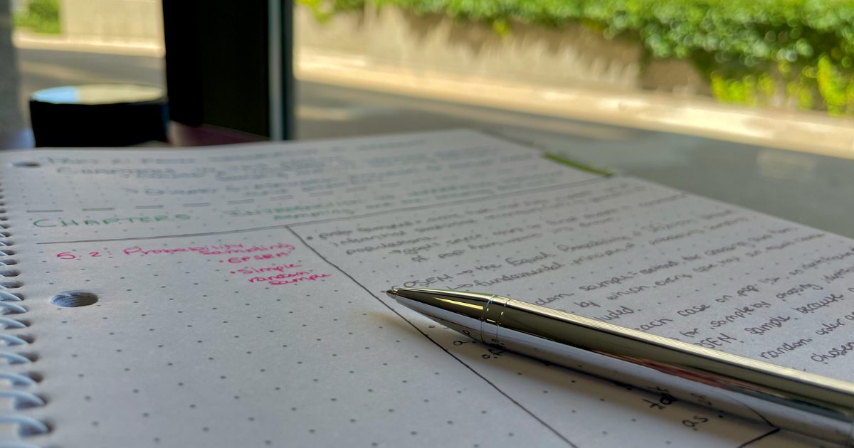 A photo of a pen sitting on top of an open notebook