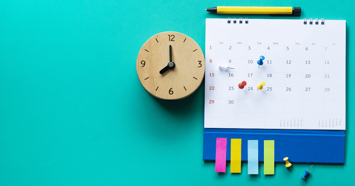 An image of a clock and a calendar with pins and sticky notes on it