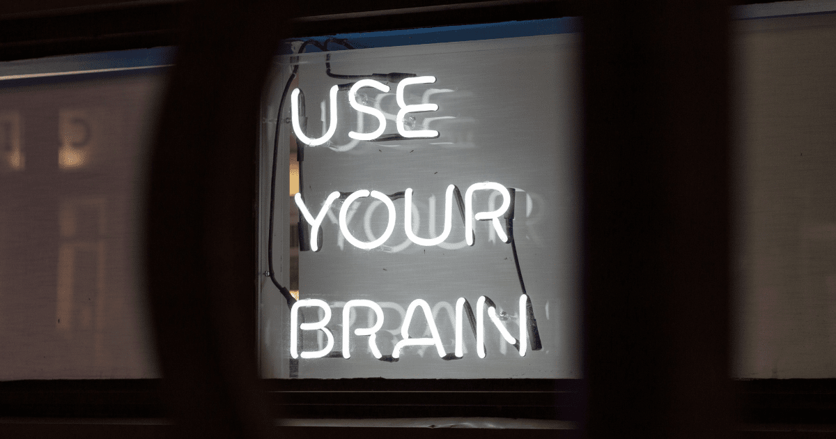 A white neon sign that reads "use your brain"