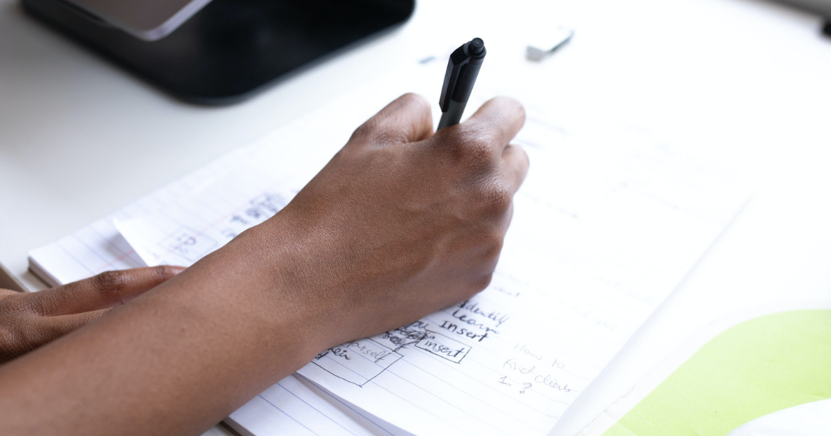 A photo of a person writing down notes