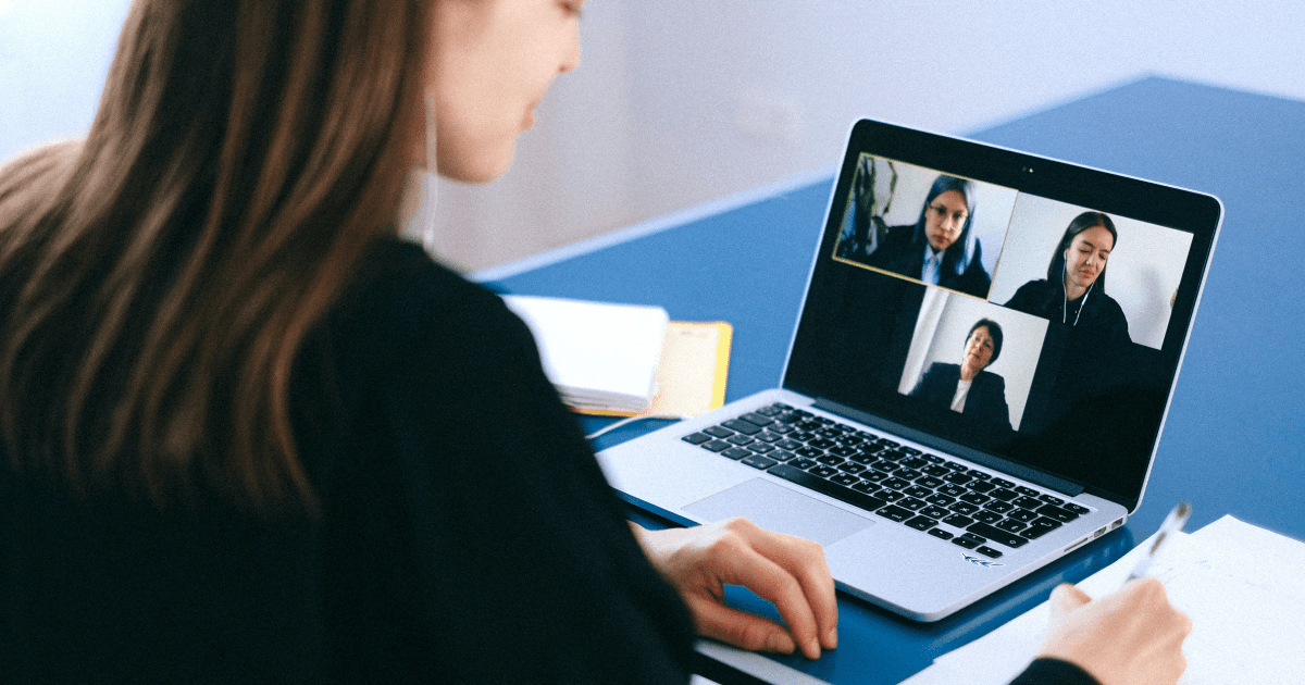 A person sitting at a computer on a Zoom call