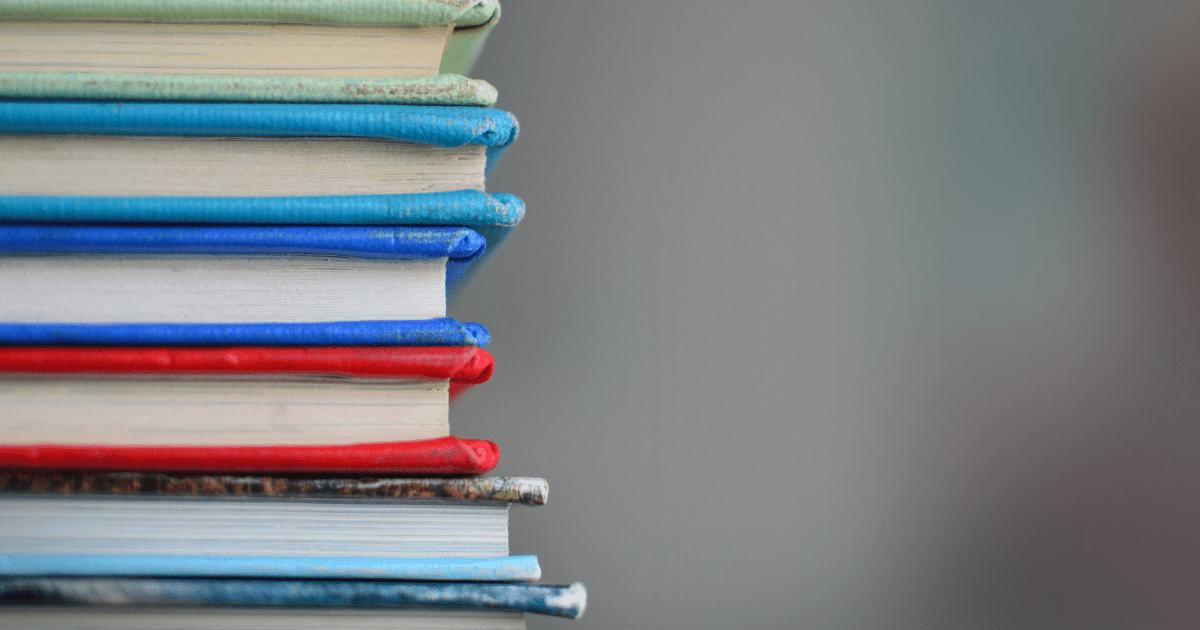 A close up image of a stack of textbooks